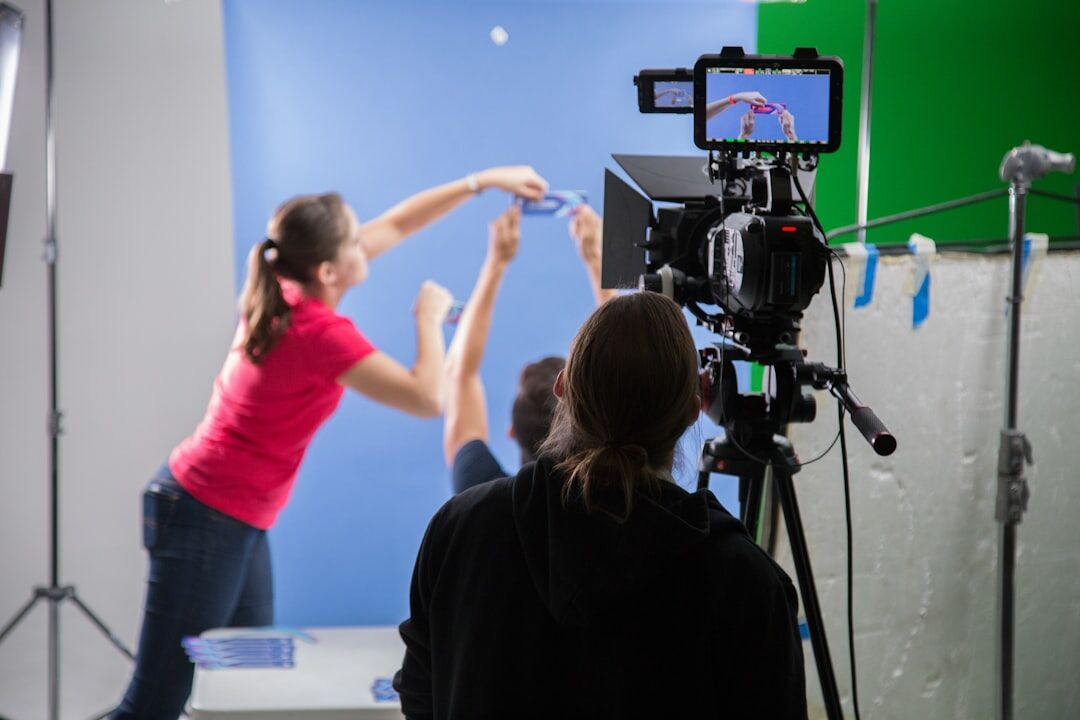 Diverse group of trainees practising live camera switching in a control room classroom